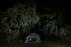 An epidemiologist works on his computer in a tent at the outbreak response camp in Itipo.