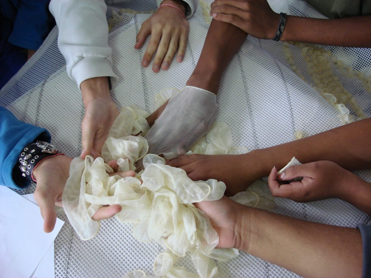 Hands touching condoms