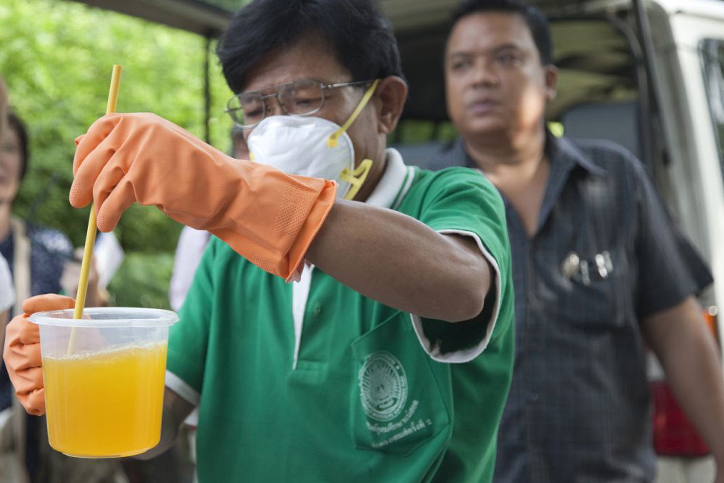 Public Health dengue prevention staff prepare mosquito repellant for a fogging operation outside Bangkok.