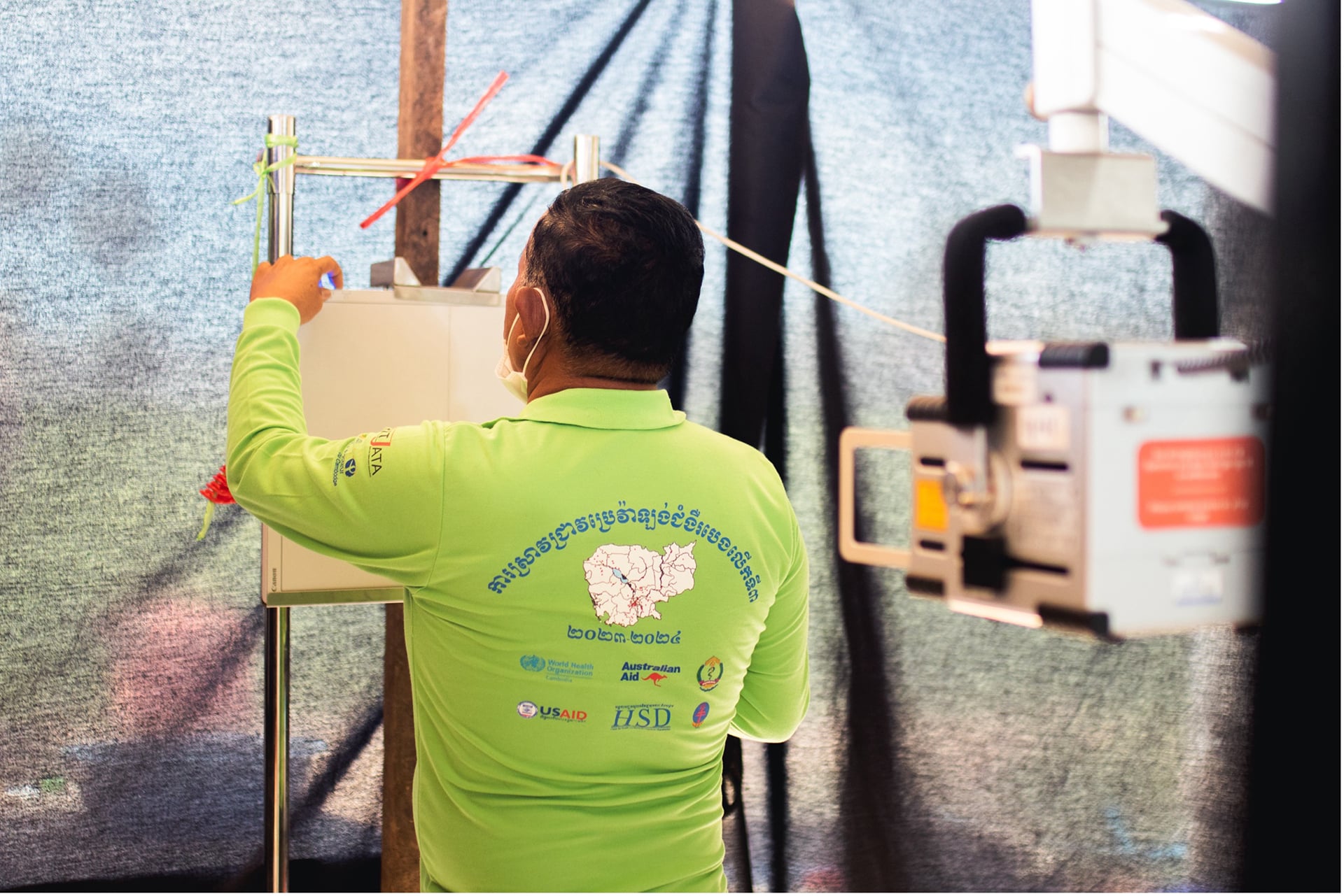 A health worker sets up the chest X-ray machine
