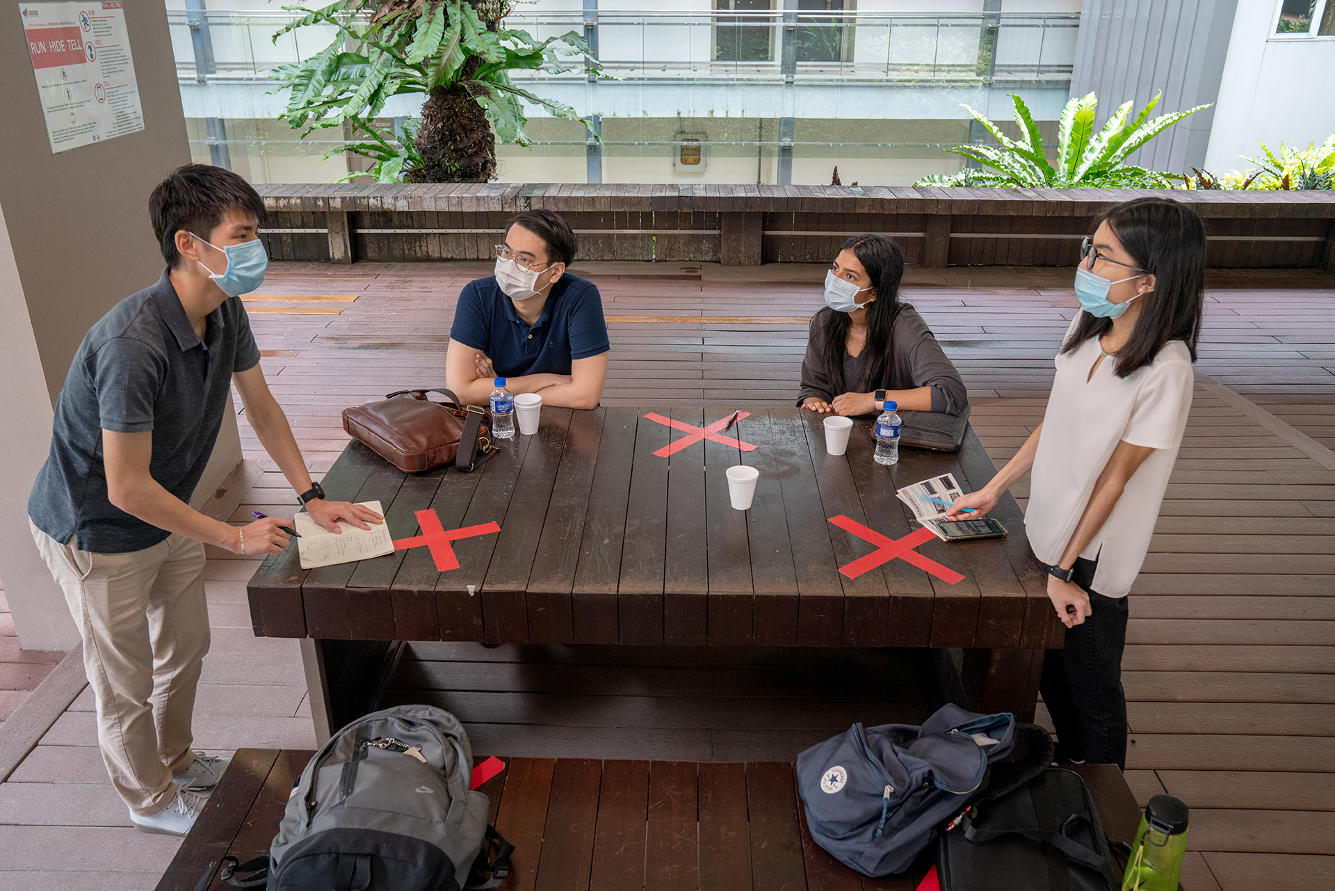 (From left) Timothy Liau brainstorms with teammates from Mind Hacks Low Jia Eu, Bhawana Sapkota and Lee Yiu Kui Rachel about mental health awareness initiatives at the Singapore Polytechnic Cafe.