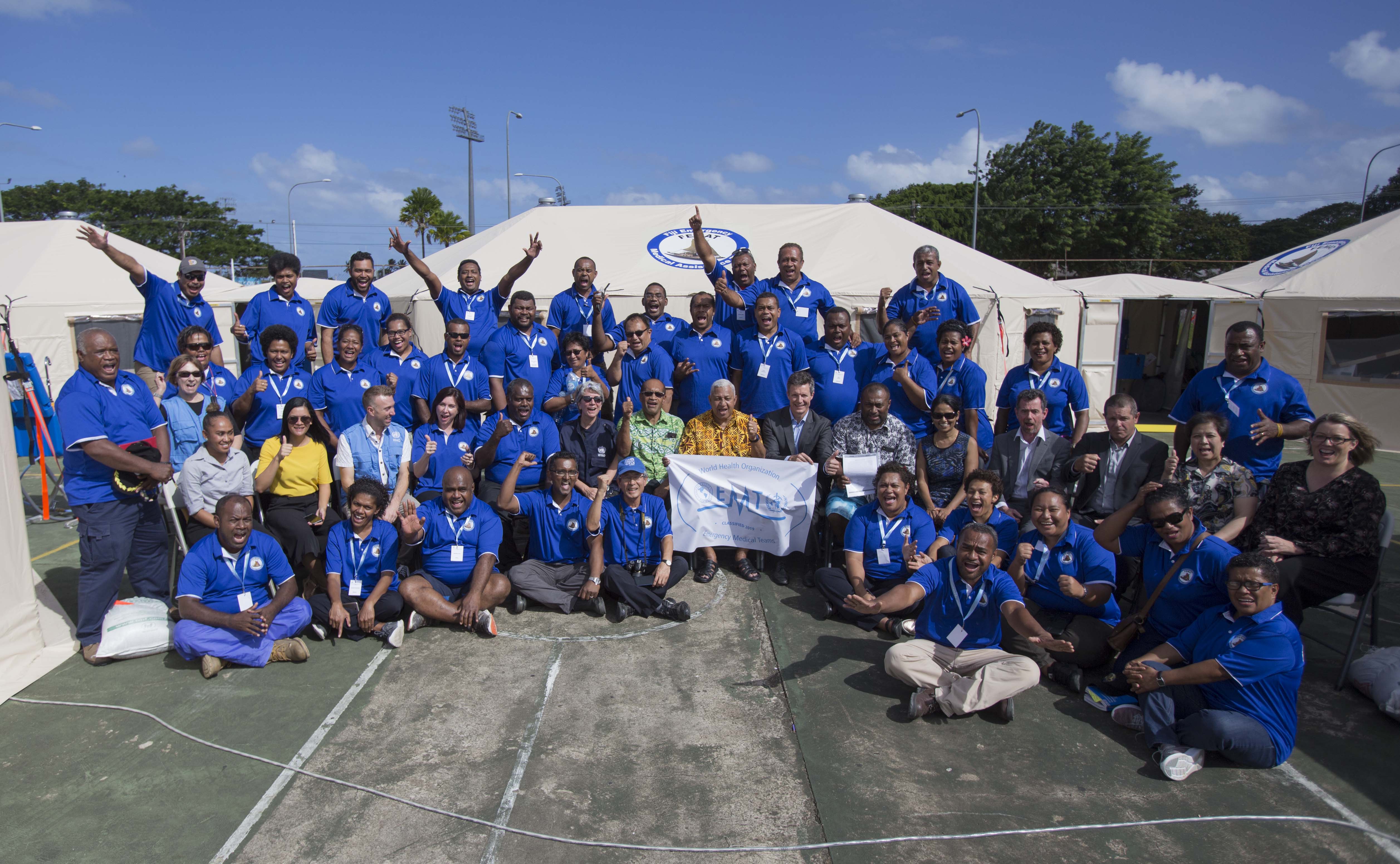 The FEMAT team alongside Prime Minister Josaia Voreqe Bainaimarama, Minister for Health & Medical Services Dr Ifereimi Waqainabete, and WHO staff, after successful verification
